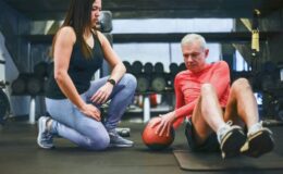 senior physical trainer working with elderly gentleman